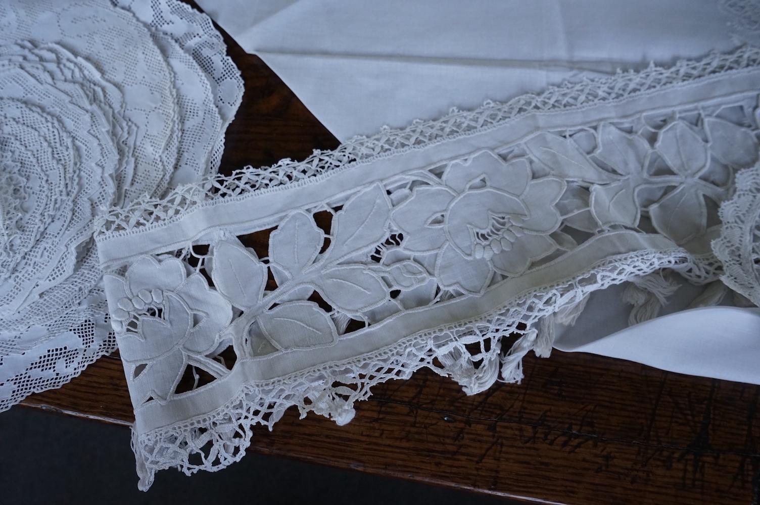 A 19th century large linen cut work collar, together with various sets of circular cut work mats, a tasselled pelmet and a collection of bobbin lace and tatting worked mats etc., Condition - mostly good